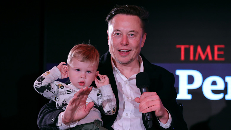 Elon Musk with X at event