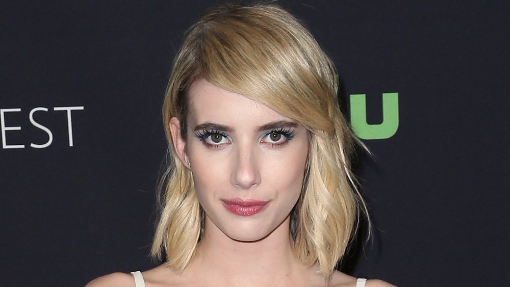 Emma Roberts staring straight at the camera with a neutral expression