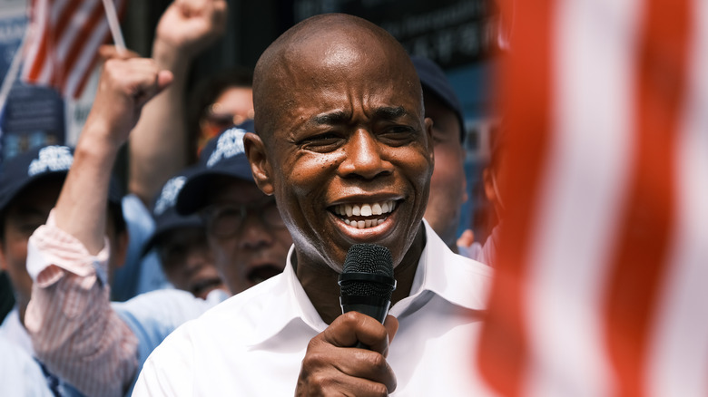 Eric Adams giving speech near an American flag