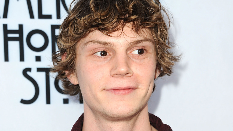 Evan Peters smiling slightly