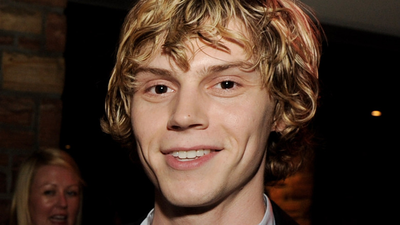 Evan Peters with shaggy hair, smiling