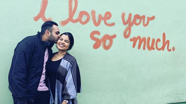 Shaan Patel, kissing Pooja on the cheek, in Austin