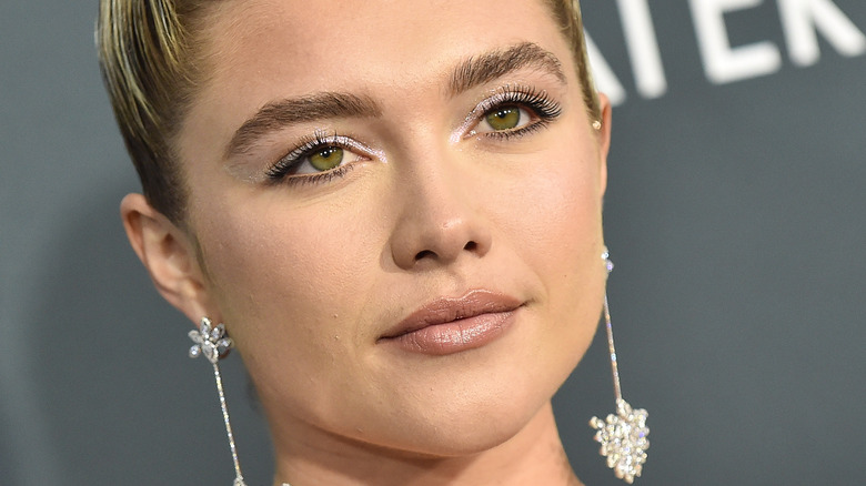 Florence Pugh with big earrings, posing