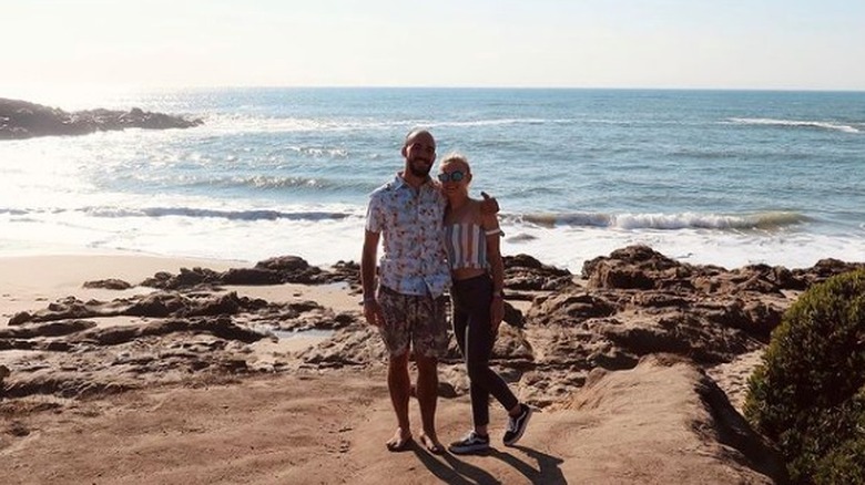 Brian Laundrie and Gabby Petito smiling with water in the background