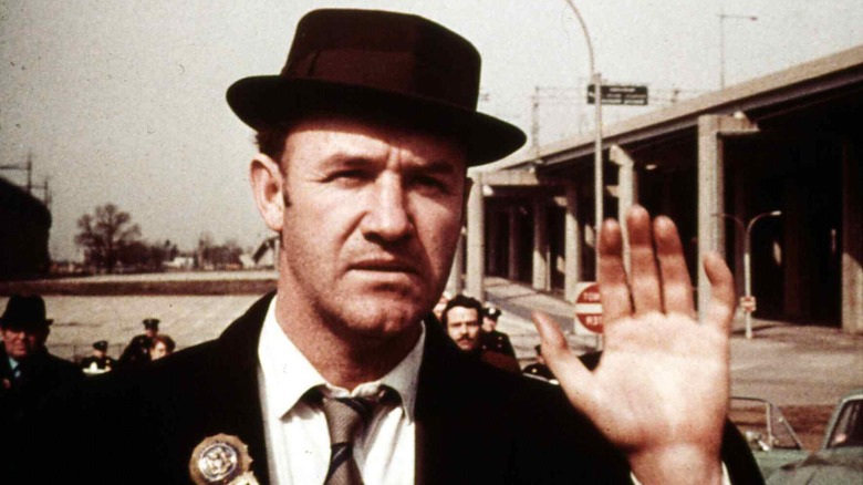 Gene Hackman in The French Connection, raising his hand