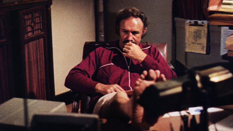 Gene Hackman in Night Moves, seated