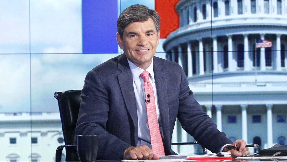 George Stephanopoulos smiling at desk