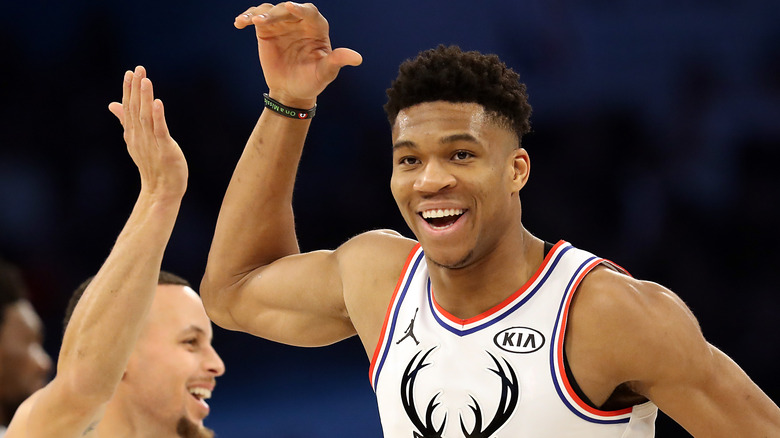 Giannis Antetokounmpo giving a high-five