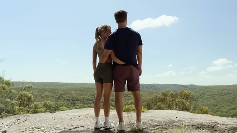 Glen Powell and Sydney Sweeny standing on cliff