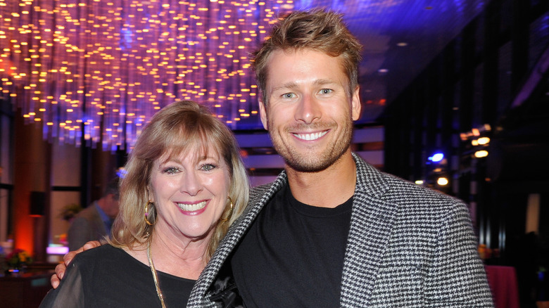 Glen Powell posing with his mom