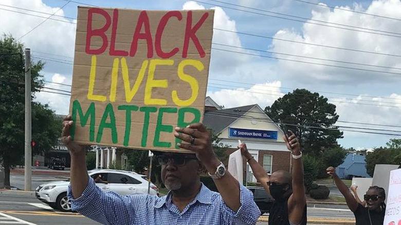 Gregg Leakes holding a "Black Lives Matter" sign