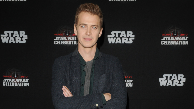 Hayden Christensen, arms crossed and posing