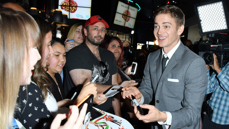 Hayden Christensen with fans, signing autographs