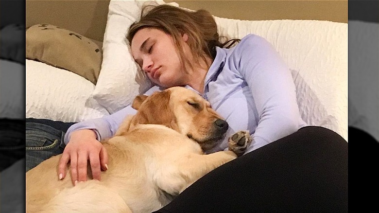 Hunter King cuddling dog Poppy