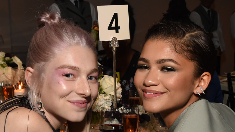 Hunter Schafer and Zendaya sitting at a table