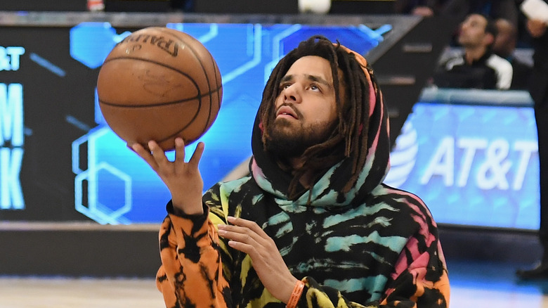 J. Cole holding a basketball