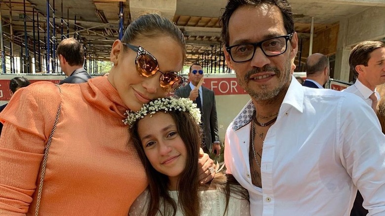 Jennifer Lopez, Emme, and Marc Anthony embrace