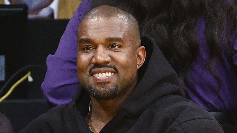 Kanye West attending Lakers game, smiling