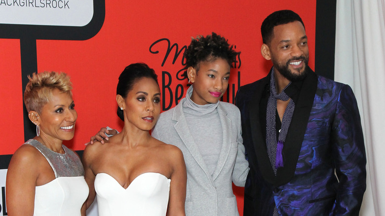 Adrienne Banfield-Norris, Jada Pinkett Smith, Willow Smith, and Will Smith posing together on the red carpet