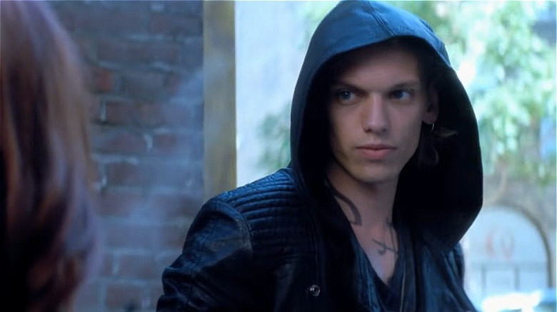 Jamie Campbell Bower with hood over head, posing