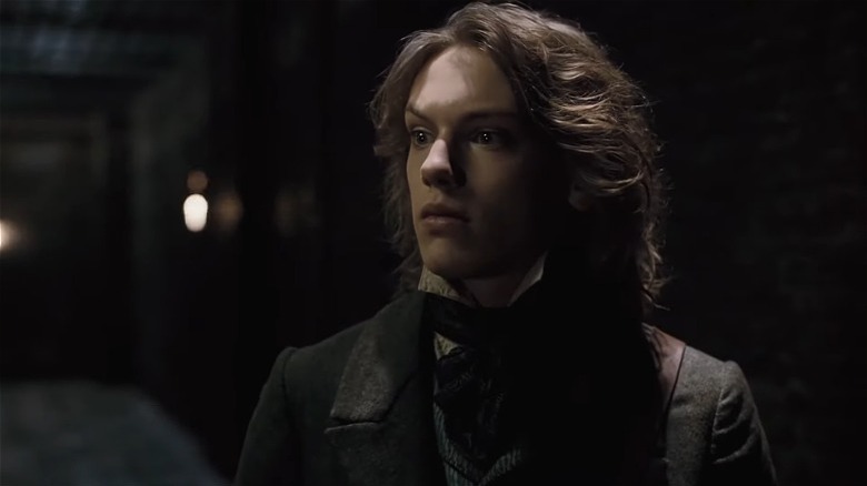 Jamie Campbell Bower as Anthony, looking surprised