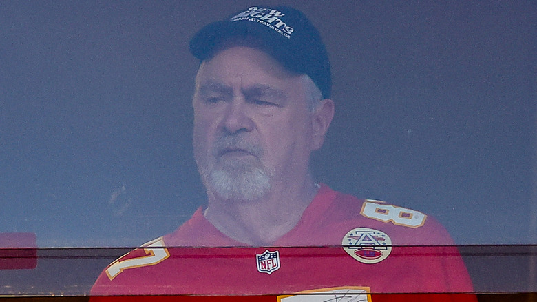 Ed Kelce watching football in a Chiefs jersey