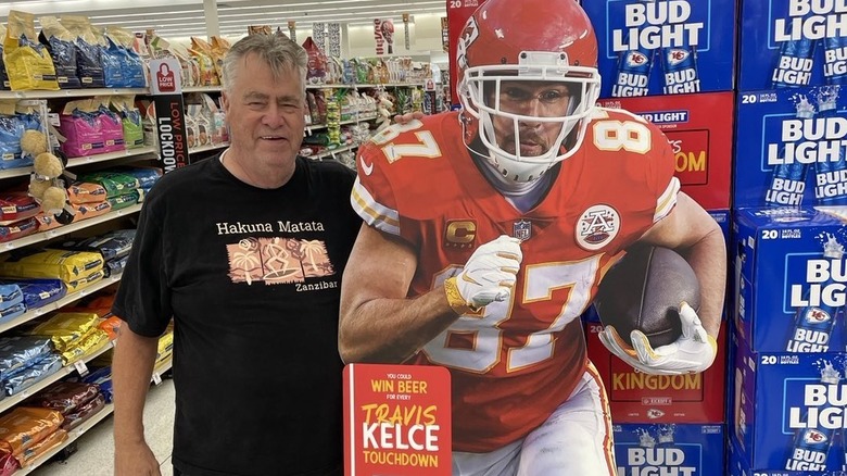 Ed Kelce posing next to a cardboard cutout of Travis Kelce