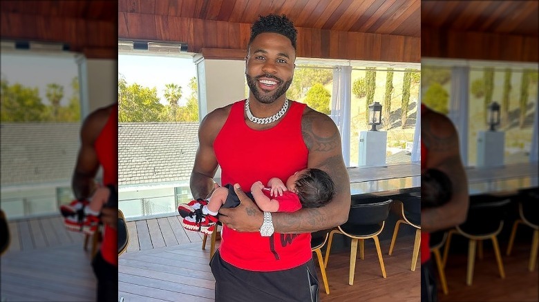 Jason Derulo holding his newborn son