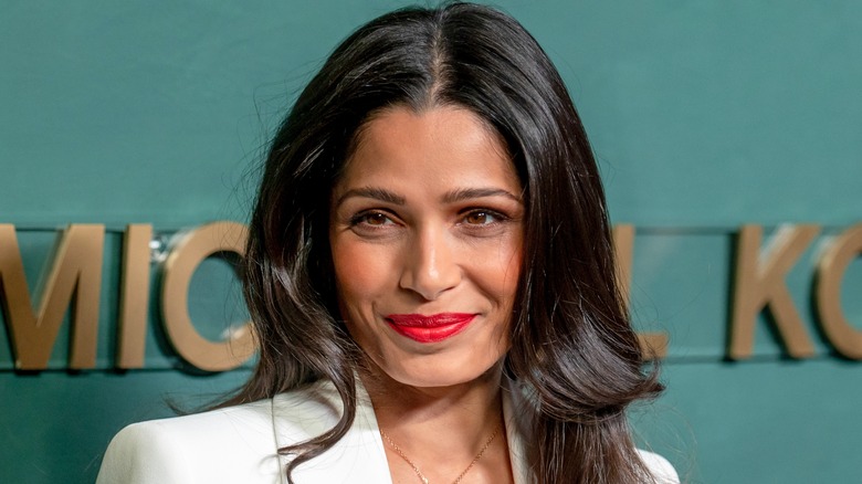 Frieda Pinto smiling for cameras on red carpet