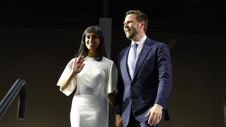 Usha and JD Vance holding hands on stage