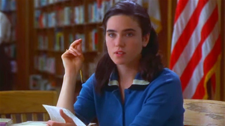 Jennifer Connelly seated, hand raised