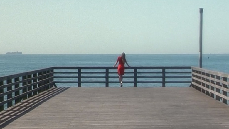 Jennifer Connelly standing on pier, leaning on railing