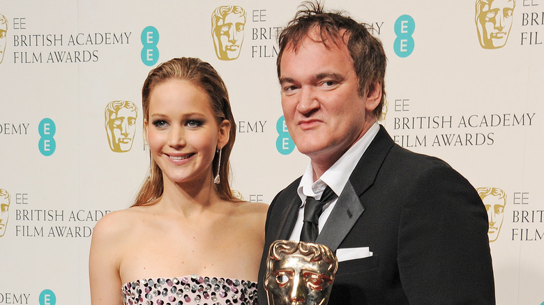 Jennifer Lawrence smiling with Quentin Tarantino at BAFTAs