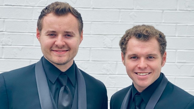 Jeremiah and Jedidiah Duggar smiling in black suits