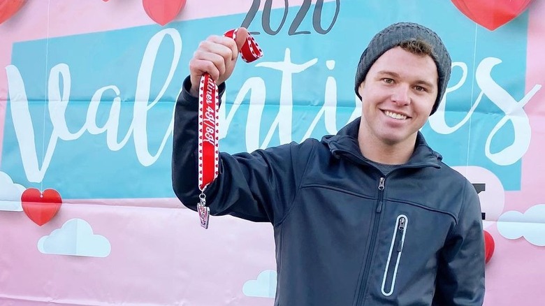 Jeremiah Duggar holding a medal 