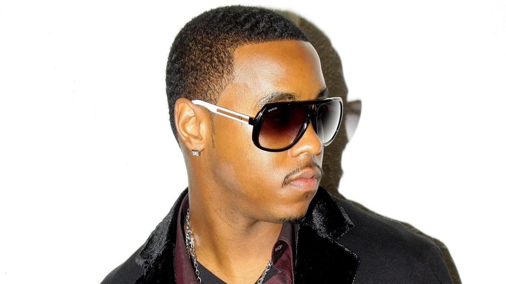 Jeremih in sunglasses and a velvet suit jacket at a fashion event