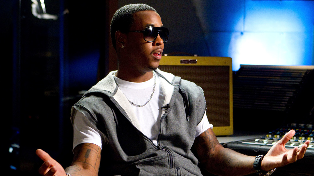 Jeremih in sunglasses, shrugging and talking in a recording studio