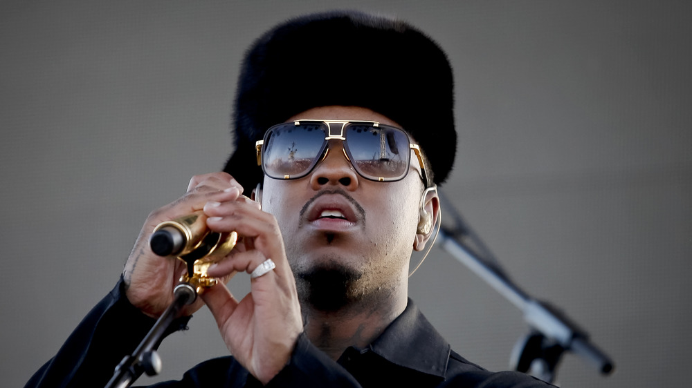 Jeremih in a fuzzy hat and sunglasses while onstage