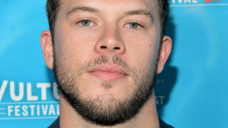 Jimmy Tatro in front of a bright blue background