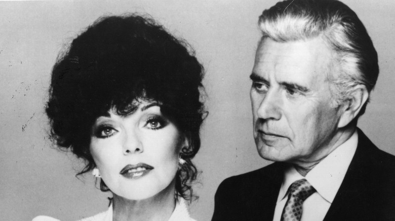 Joan Collins and John Forsythe posing