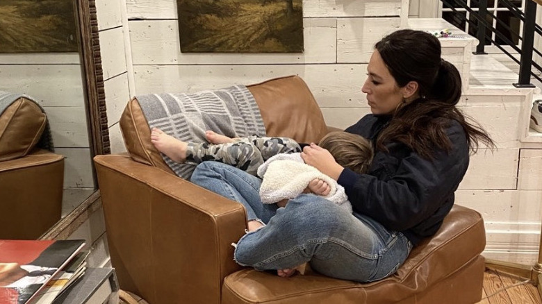 Joanna Gaines cradling a child