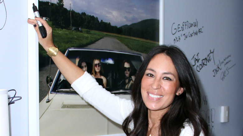 Joanna Gaines signing a wall