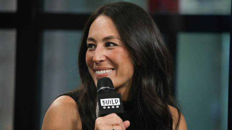 Joanna Gaines holding microphone