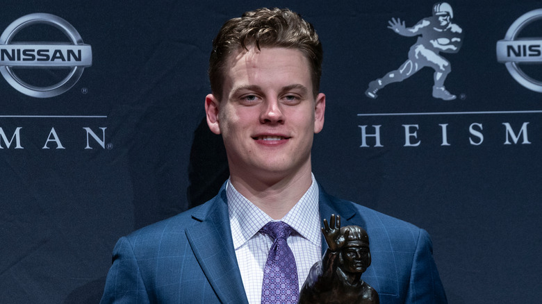 Joe Burrow smiling with Heisman Trophy