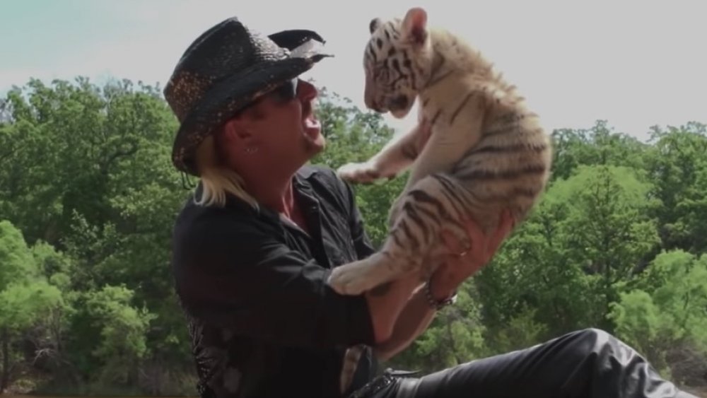 Joe Exotic holding baby tiger