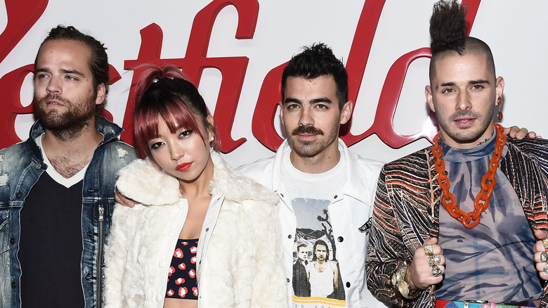 DNCE posing at an event