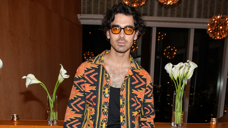 Joe Jonas posing at a fashion week party