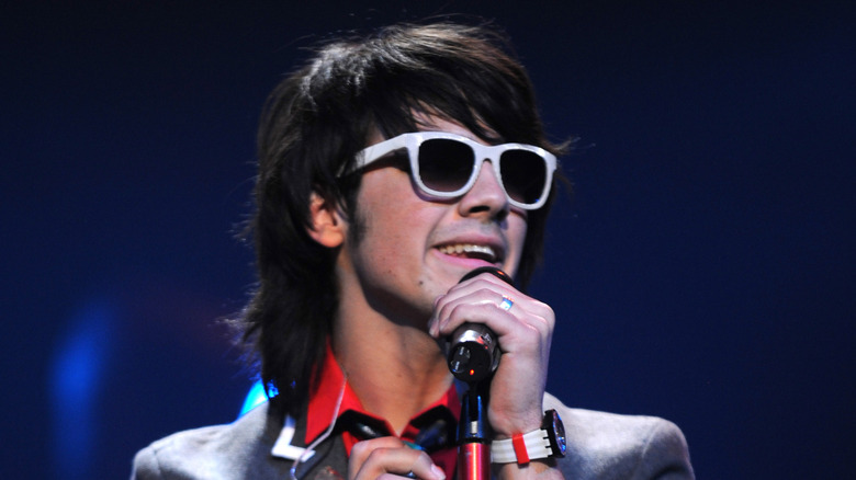 Joe Jonas performing on stage as a teenager