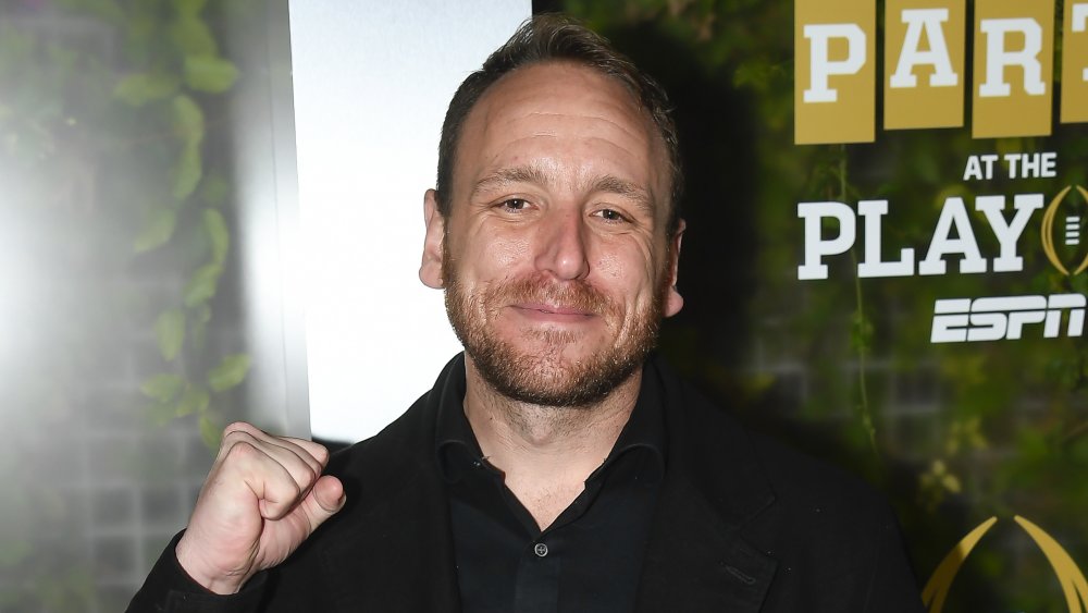 Joey Chestnut posing at an event with one fist up