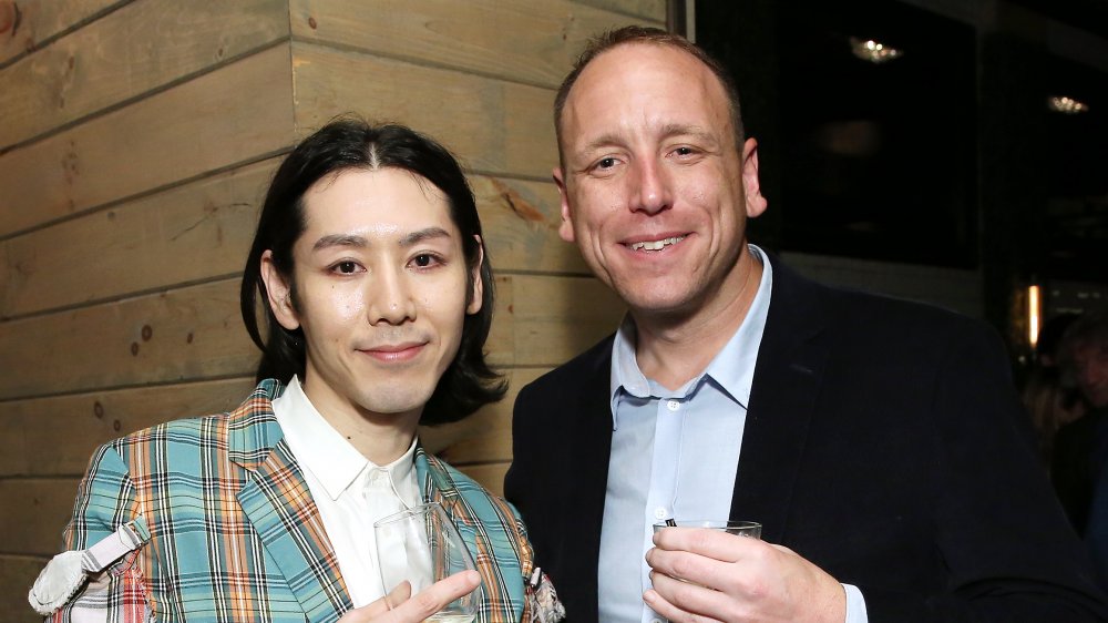 Takeru Kobayashi, Joey Chestnut posing together at an event